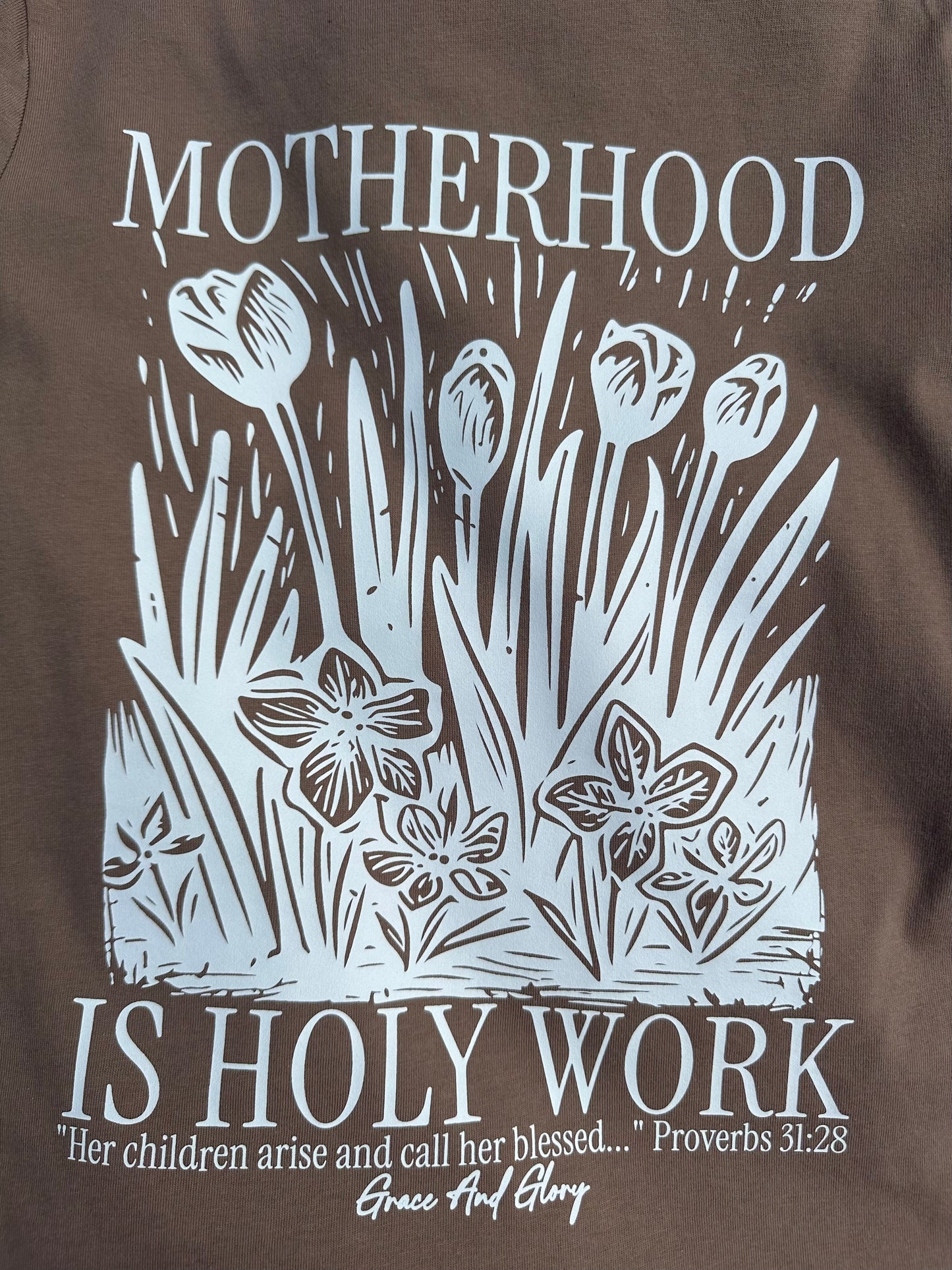 Motherhood is Holy Work Women’s Tee – Brown